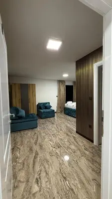 a room with two blue couches and a bedroom at Motel i Restoran Krajina in Cazin