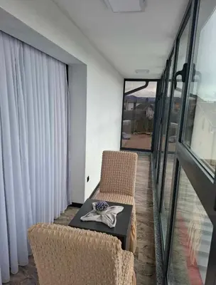 a room with a table and chairs and a balcony at Motel i Restoran Krajina in Cazin