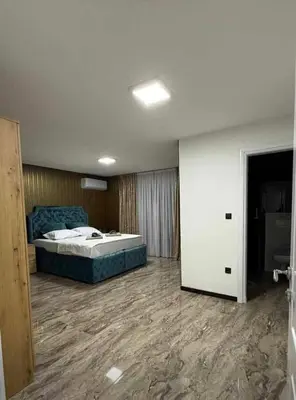 a bedroom with a large bed in a room at Motel i Restoran Krajina in Cazin