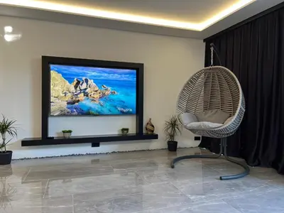 a living room with a wicker chair and a flat screen tv at villa M&B in Zbilje