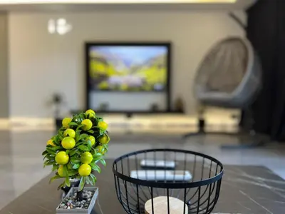a living room with a table with a vase of fruit at villa M&B in Zbilje