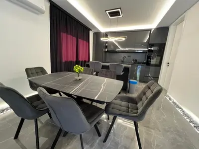 a dining room with a table and chairs at villa M&B in Zbilje