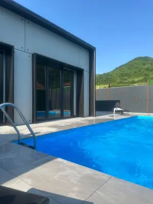 a swimming pool in front of a building at villa M&B in Zbilje