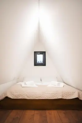 a white room with a bed with a mirror at The Sky Hill - luxury chalet in Kupres