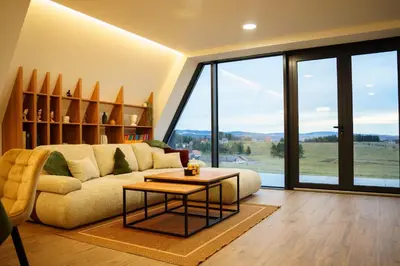 a living room with a couch and a table at The Sky Hill - luxury chalet in Kupres