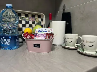 a table with two coffee cups and a bottle of water at Chill In Apartman in Banja Luka