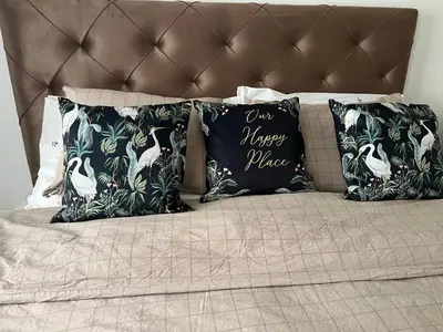a bed with four pillows on top of it at Chill In Apartman in Banja Luka