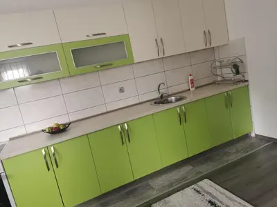 a kitchen with green cabinets and a sink at smještaj Visoko in Visoko