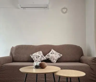 a living room with a brown couch and a table at Livno Sympan in Livno