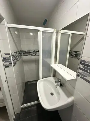a white bathroom with a sink and a shower at Banja Luka Arcadia in Banja Luka