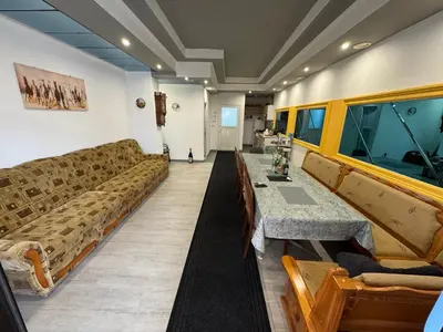 a living room with couches and a table in a room at Banja Luka Arcadia in Banja Luka
