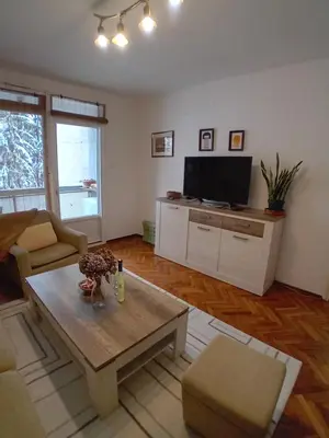 a living room with a couch and a tv at Apartman BRKO in Bihać