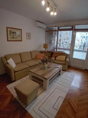 a living room with a couch and a coffee table at Apartman BRKO in Bihać