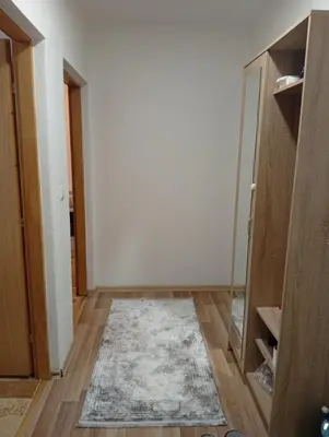 an empty room with a rug on a wooden floor at Apartman Školska in Travnik