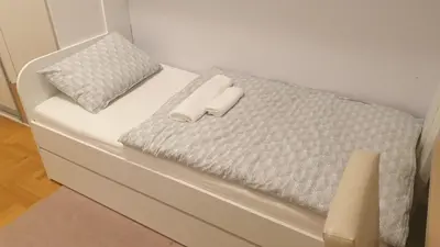 a white bed with two white pillows on it at Apartman 44, Mejdan, Banja Luka in Banja Luka