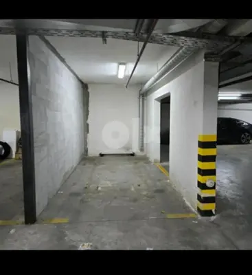 an empty parking garage with a car parked in it at Apartman 44, Mejdan, Banja Luka in Banja Luka