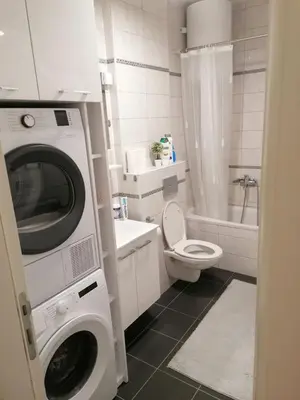 a bathroom with a washing machine and a toilet at Apartman 44, Mejdan, Banja Luka in Banja Luka