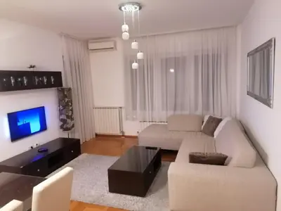 a living room with a couch and a tv at Apartman 44, Mejdan, Banja Luka in Banja Luka