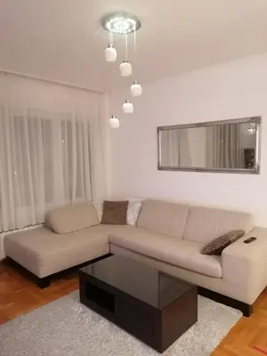 a living room with a couch and a coffee table at Apartman 44, Mejdan, Banja Luka in Banja Luka