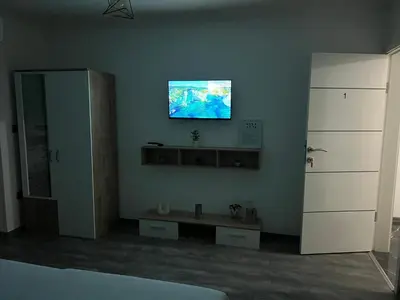 a living room with a tv on the wall at DM Rooms l in Gornji Vakuf