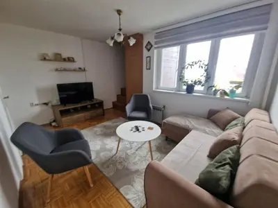 a living room with a couch and a table at Apartman Sofija 3 in Starčevica