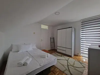 a bedroom with a bed with two towels on it at Apartman Sofija 3 in Starčevica