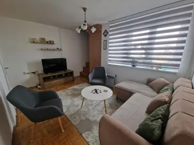 a living room with a couch and a table at Apartman Sofija 3 in Starčevica