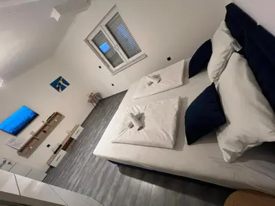 a bedroom with a large white bed with two pillows at DM Rooms ll in Gornji Vakuf