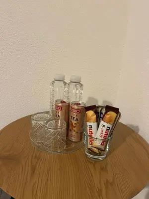 a table with a group of soda bottles and cups at DM Rooms ll in Gornji Vakuf