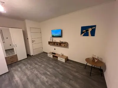 an empty living room with a camera on the wall at DM Rooms ll in Gornji Vakuf