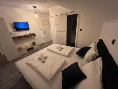 a bedroom with two white beds with bows on them at DM Rooms lll in Gornji Vakuf