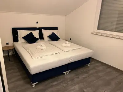 a bedroom with a bed with two swans on it at DM Rooms lll in Gornji Vakuf