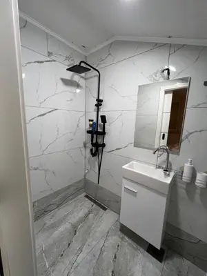 a white bathroom with a sink and a mirror at DM Rooms lll in Gornji Vakuf