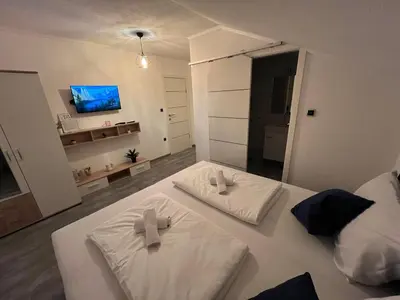 a bedroom with two white towels on a bed at DM Rooms lll in Gornji Vakuf
