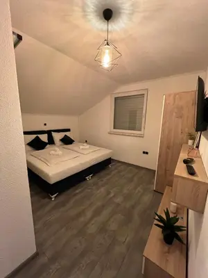 a bedroom with a bed and a ceiling at DM Rooms lll in Gornji Vakuf