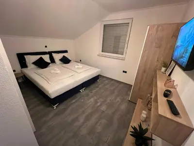 a bedroom with a bed and a desk and a television at DM Rooms lll in Gornji Vakuf