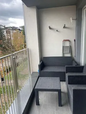 a balcony with two chairs and a bench on a balcony at Apartman Klara Banja Luka in Banja Luka