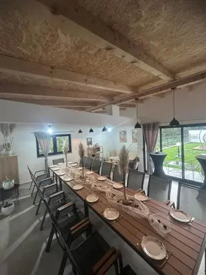 a large long table in a room with chairs at Villa Perla in Prijedor