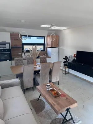 a living room with a table and a dining room at Villa Perla in Prijedor
