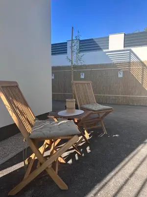 two chairs and a table on a patio at Villa Perla in Prijedor