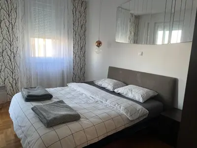 a bedroom with a bed with two towels on it at Apartman Dona in Banja Luka