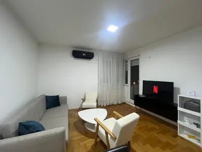 a living room with a couch and a tv at Apartman Dona in Banja Luka
