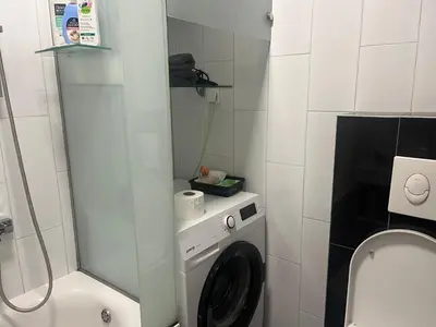 a bathroom with a washing machine and a toilet at Apartman Dona in Banja Luka