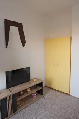 a living room with a flat screen tv and a cabinet at Banja Luka Lux in Banja Luka