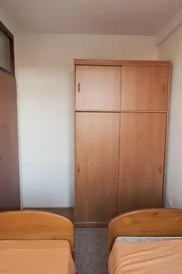 a bedroom with two beds and a closet at Banja Luka Lux in Banja Luka