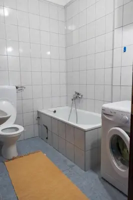 a bathroom with a toilet and a washing machine at Banja Luka Lux in Banja Luka