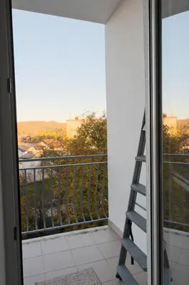 a room with a balcony with a ladder at Banja Luka Lux in Banja Luka