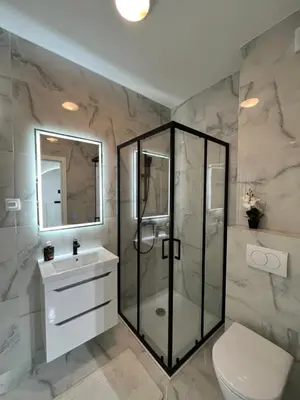 a bathroom with a shower and a toilet and a sink at Gold Panorama Apartment 27 in Banja Luka