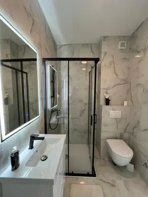 a bathroom with a shower and a sink and a toilet at Gold Panorama Apartment 27 in Banja Luka