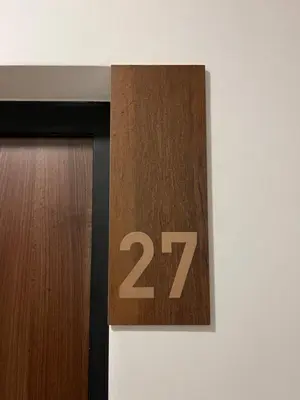 a wooden door with the number twenty seven on it at Gold Panorama Apartment 27 in Banja Luka